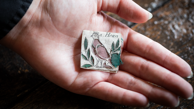 A close up of a 17th century papercutting depicting a hen